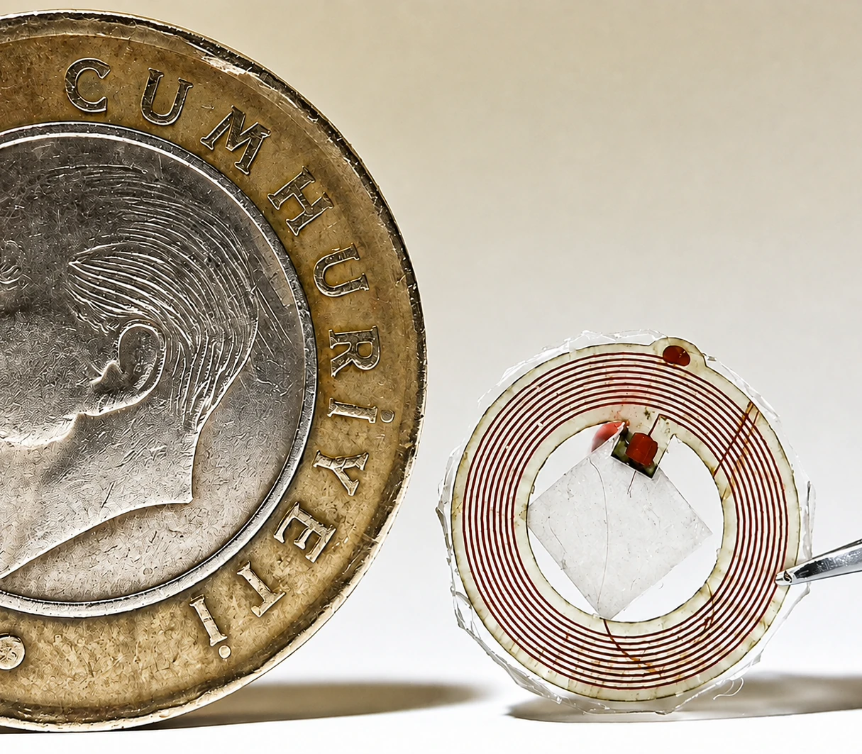 Compact ultrasonic tag shown beside a coin